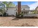 This backyard features a chimney, partially covered porch, and privacy; excellent for outdoor entertainment at 3308 Churchill Rd, Raleigh, NC 27607