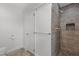 Bathroom features a tiled shower with rock base and toilet with towel bar at 3308 Churchill Rd, Raleigh, NC 27607
