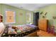 Bedroom features hardwood floors, closet, and a bed with a colorful quilt at 3308 Churchill Rd, Raleigh, NC 27607