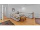 Cozy bedroom showcasing hardwood floors, a colorful quilt, and classic decor at 3308 Churchill Rd, Raleigh, NC 27607