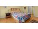 Bedroom features a colorful quilt and built-in headboard with shelving; side table at 3308 Churchill Rd, Raleigh, NC 27607