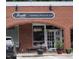 The outside of a cafe with tables and chairs, plants and black SUV out front at 3308 Churchill Rd, Raleigh, NC 27607