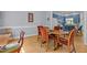 Light-filled dining room featuring hardwood floors, a wood table with seating, and blue accent walls at 3308 Churchill Rd, Raleigh, NC 27607