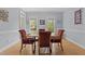 Dining room featuring hardwood floors, a wood table with seating, and neutral color walls at 3308 Churchill Rd, Raleigh, NC 27607