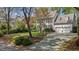 Traditional two-story home with a well-maintained lawn, mature trees, a two-car garage, and driveway at 3308 Churchill Rd, Raleigh, NC 27607