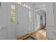 Bright foyer featuring hardwood floors, a front door with sidelights, and an open view to another room at 3308 Churchill Rd, Raleigh, NC 27607