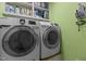 A well-equipped laundry room with washer, dryer, and shelving for organizing essentials at 3308 Churchill Rd, Raleigh, NC 27607