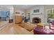 Spacious living room featuring brick fireplace, hardwood floors and comfortable seating at 3308 Churchill Rd, Raleigh, NC 27607