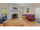 Cozy living room with brick fireplace, hardwood floors, and comfortable seating at 3308 Churchill Rd, Raleigh, NC 27607