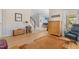 Open living area featuring hardwood floors and access to porch, kitchen and staircase at 3308 Churchill Rd, Raleigh, NC 27607