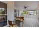 Covered porch offers outdoor seating with ceiling fan, and backyard views at 3308 Churchill Rd, Raleigh, NC 27607
