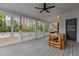 Covered porch with ceiling fan and wooden table offers an inviting outdoor space at 3308 Churchill Rd, Raleigh, NC 27607