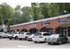 Brick shopping center featuring several storefronts, with parked cars in front at 3308 Churchill Rd, Raleigh, NC 27607
