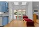 Bright sunroom with hardwood floors, skylights, and daybed overlooking the porch at 3308 Churchill Rd, Raleigh, NC 27607