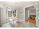 Cozy dining area featuring a table with bench seating, a large window, and stylish flooring at 34 Stuart Dr, Benson, NC 27504