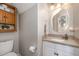 Well-lit half bathroom boasts a modern vanity, decorative mirror and fixtures, and a convenient layout at 34 Stuart Dr, Benson, NC 27504