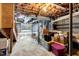 Unfinished basement with exposed ductwork, cement flooring and storage at 3508 Cole Mill Rd, Durham, NC 27712