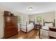 Bright bedroom featuring twin beds, natural light, and classic furnishings at 3508 Cole Mill Rd, Durham, NC 27712