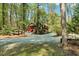 Charming two-story home nestled among mature trees and a spacious driveway at 3508 Cole Mill Rd, Durham, NC 27712