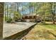 Exterior view of the home from the gravel driveway and partial lawn at 3508 Cole Mill Rd, Durham, NC 27712