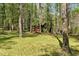 Lush front yard with mature trees create a tranquil, shaded setting for this property at 3508 Cole Mill Rd, Durham, NC 27712