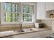 Kitchen sink and granite counter top surrounded by two windows at 3508 Cole Mill Rd, Durham, NC 27712