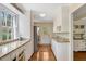 Bright kitchen with stainless steel appliances, ample counter space and white cabinets at 3508 Cole Mill Rd, Durham, NC 27712