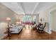 Spacious living room with hardwood floors, ample seating, and a serene ambiance at 3508 Cole Mill Rd, Durham, NC 27712