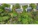 Aerial view of the house with a manicured lawn, fenced backyard, and mature trees at 3517 Boren Ct, Raleigh, NC 27616