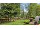 Large backyard with a wooden fence, mature trees, and a lush green lawn at 3517 Boren Ct, Raleigh, NC 27616