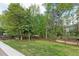Expansive backyard features mature trees and a wooden fence, perfect for outdoor activities at 3517 Boren Ct, Raleigh, NC 27616