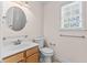 Well-lit bathroom with a vanity, toilet, and towel rack at 3517 Boren Ct, Raleigh, NC 27616