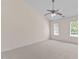 Spacious carpeted bedroom featuring a vaulted ceiling and large windows at 3517 Boren Ct, Raleigh, NC 27616