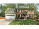 Traditional brick home with black shutters, a red front door, and green grass at 3517 Boren Ct, Raleigh, NC 27616