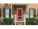 Close up of the inviting front porch with its bright red door, and decorative brick surround at 3517 Boren Ct, Raleigh, NC 27616