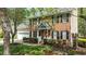 Charming two-story brick home with a well-manicured lawn, red front door, and attached two-car garage at 3517 Boren Ct, Raleigh, NC 27616