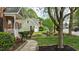Charming two-story brick home with a well-manicured lawn, and a walkway leading to the front door at 3517 Boren Ct, Raleigh, NC 27616
