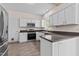Kitchen view with stainless steel appliances, white cabinets, and dark countertops at 3517 Boren Ct, Raleigh, NC 27616