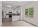 Charming kitchen with white cabinetry, stainless steel appliances, and a view to the backyard at 3517 Boren Ct, Raleigh, NC 27616
