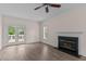 Bright living room with hardwood flooring, a fireplace, and access to an outdoor deck at 3517 Boren Ct, Raleigh, NC 27616