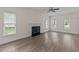 Well-lit living room with a fireplace, ceiling fan, and beautiful flooring at 3517 Boren Ct, Raleigh, NC 27616
