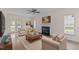 Inviting living room featuring a fireplace, ceiling fan and access to an outdoor deck at 3517 Boren Ct, Raleigh, NC 27616