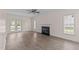 Bright living room with hardwood flooring, a fireplace, and multiple windows at 3517 Boren Ct, Raleigh, NC 27616