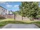 Fenced backyard with lush green grass and a beautiful mature tree offering shade at 360 Callandale Ln, Durham, NC 27703