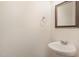 This bathroom features a white pedestal sink, faucet and mirror at 360 Callandale Ln, Durham, NC 27703