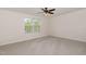 Spacious carpeted bedroom features a ceiling fan and a window with views at 360 Callandale Ln, Durham, NC 27703