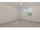 This carpeted bedroom has neutral walls and a window to provide natural light at 360 Callandale Ln, Durham, NC 27703
