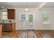 Dining area with wood flooring, a pendant light, and a double door at 360 Callandale Ln, Durham, NC 27703