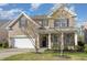 Charming two-story brick home with a two car garage and well-manicured lawn at 360 Callandale Ln, Durham, NC 27703