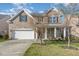 Charming two-story brick home with a two car garage and well-manicured lawn at 360 Callandale Ln, Durham, NC 27703